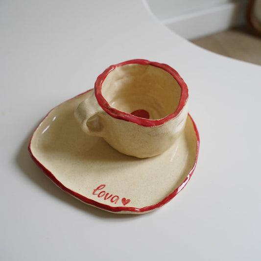 Ceramic cup with red interior on a white background