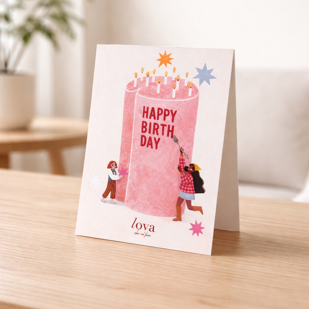 Birthday card with pink cake illustration on a wooden table