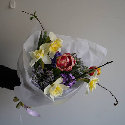 Fresh spring flower bouquet with yellow daffodils pink tulips and purple hyacinths Portugal