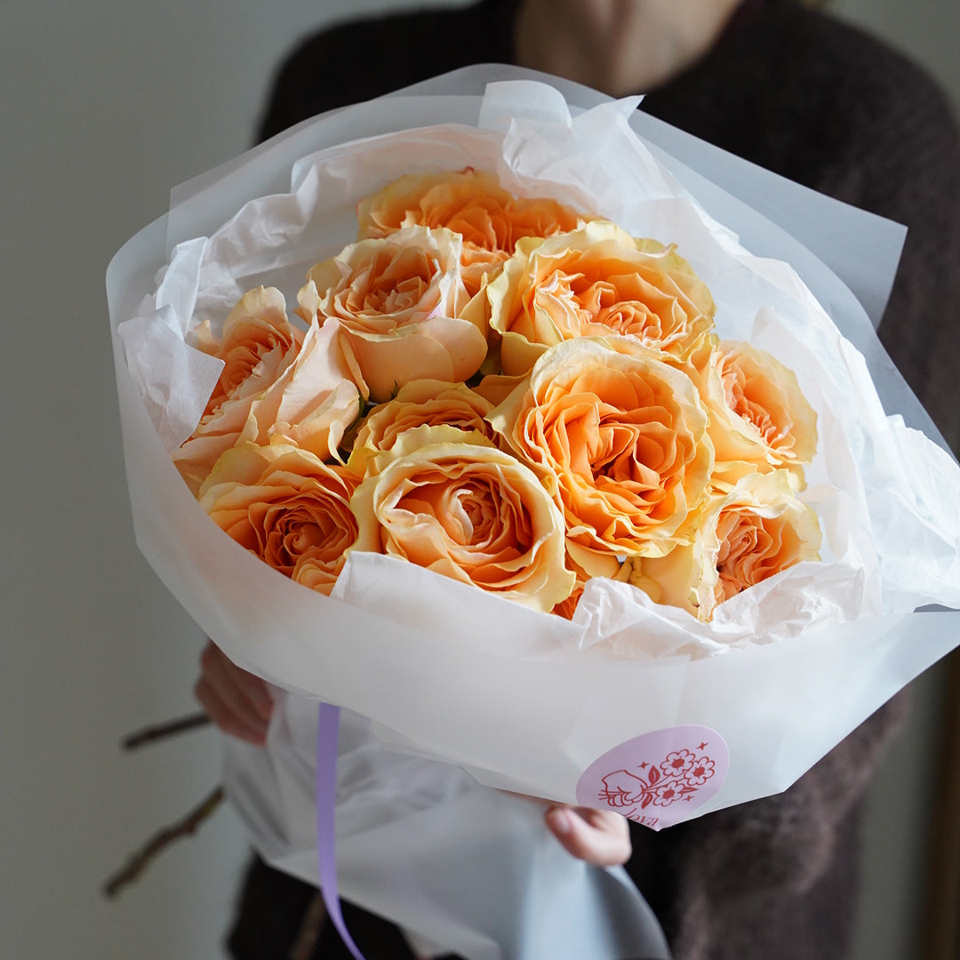Peach roses bouquet with 21 stems, romantic peach-colored roses wrapped in white paper