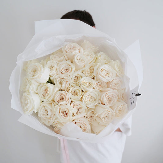 Large bouquet of white garden roses in minimalist wrapping, luxury flower bouquet by Lova