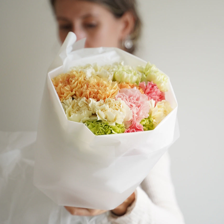 Small mixed dianthus bouquet with 15 stems, pastel pink peach and green flowers in white wrapping