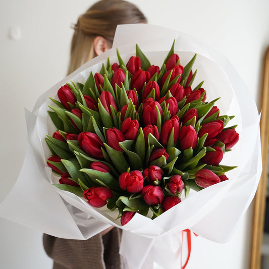 Classic red tulips bouquet gift, seasonal flowers wrapped in white paper
