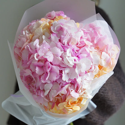 Small marshmallow hydrangea bouquet with 5 stems, pink and peach flowers in white wrapping