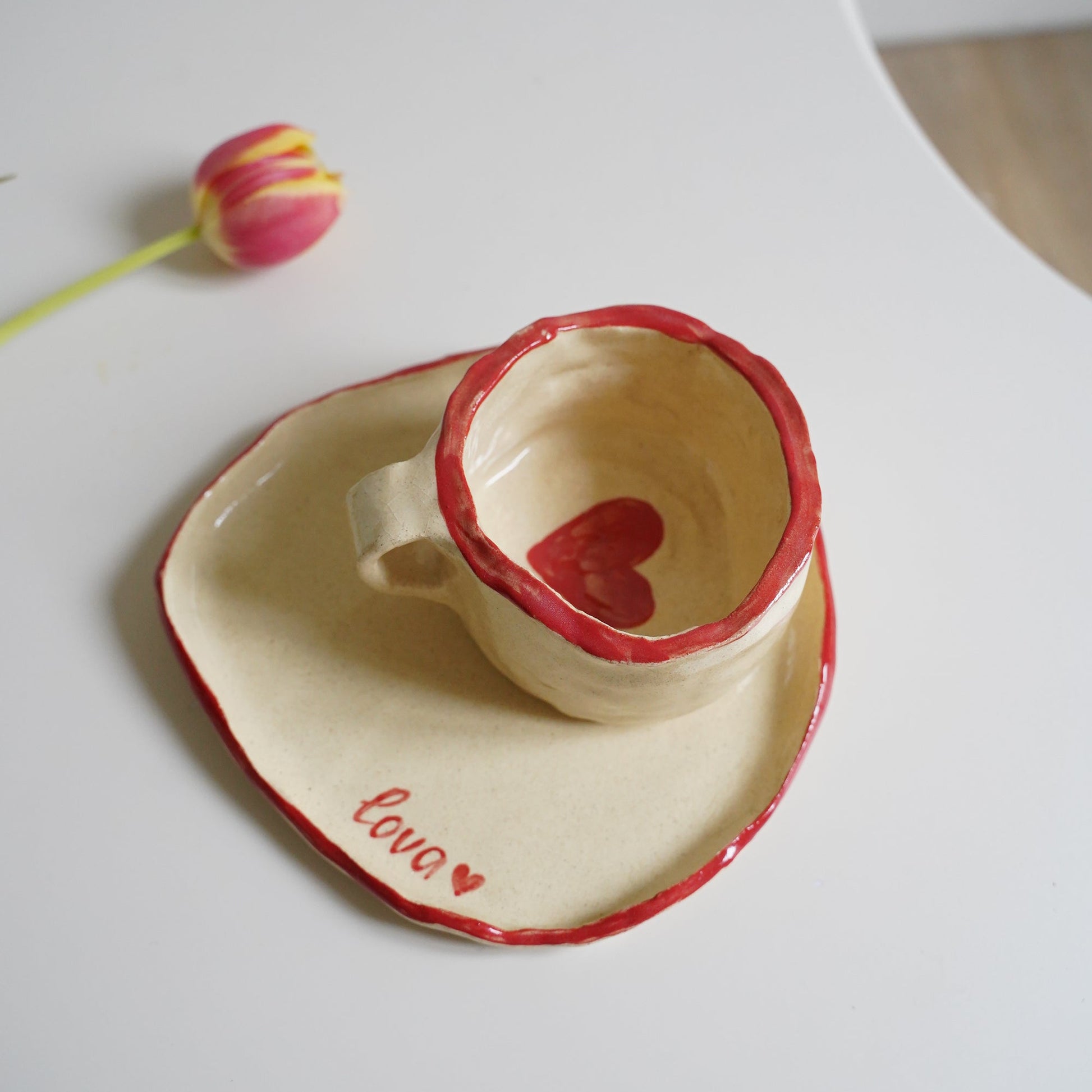 Heart-shaped ceramic product with 'love' text on a white background